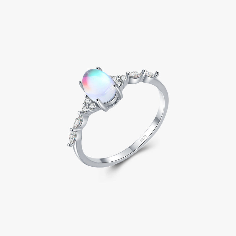 Stackable sterling silver moonstone ring on finger, Ins style moonstone ring with celestial glow, Recycled silver moonstone stacking band jewelry,Close-up of natural moonstone in silver ring setting, Minimalist moonstone ring for layered arm candy
