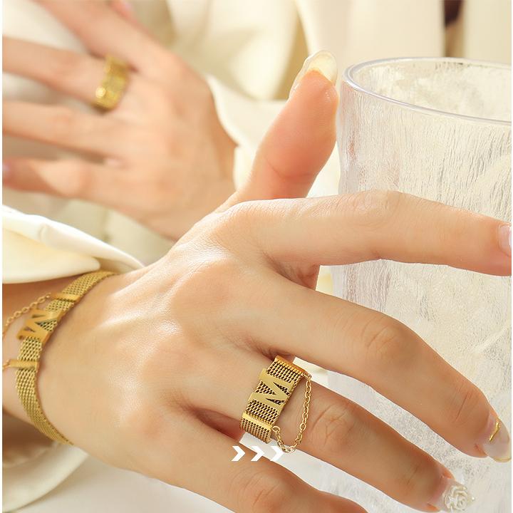 Titanium steel 18K gold plated geometric stripe ring on hand, Close-up of horizontal striped design on gold plated ring, Luxury gift box with 18K gold titanium steel jewelry, Water-resistant gold plated ring with recycled titanium steel,Two-year guarantee hypoallergenic gold tone ring