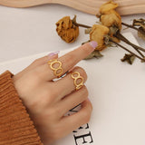 Titanium steel 18K gold plated geometric stripe ring on hand, Close-up of horizontal striped design on gold plated ring, Luxury gift box with 18K gold titanium steel jewelry, Water-resistant gold plated ring with recycled titanium steel,Two-year guarantee hypoallergenic gold tone ring