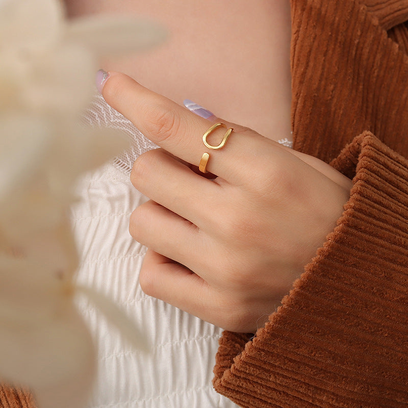 Titanium steel 18K gold plated geometric stripe ring on hand, Close-up of horizontal striped design on gold plated ring, Luxury gift box with 18K gold titanium steel jewelry, Water-resistant gold plated ring with recycled titanium steel,Two-year guarantee hypoallergenic gold tone ring