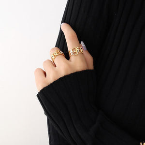 Titanium steel 18K gold plated geometric stripe ring on hand, Close-up of horizontal striped design on gold plated ring, Luxury gift box with 18K gold titanium steel jewelry, Water-resistant gold plated ring with recycled titanium steel,Two-year guarantee hypoallergenic gold tone ring