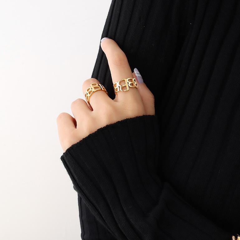 Titanium steel 18K gold plated geometric stripe ring on hand, Close-up of horizontal striped design on gold plated ring, Luxury gift box with 18K gold titanium steel jewelry, Water-resistant gold plated ring with recycled titanium steel,Two-year guarantee hypoallergenic gold tone ring