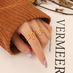 Titanium steel 18K gold plated geometric stripe ring on hand, Close-up of horizontal striped design on gold plated ring, Luxury gift box with 18K gold titanium steel jewelry, Water-resistant gold plated ring with recycled titanium steel,Two-year guarantee hypoallergenic gold tone ring