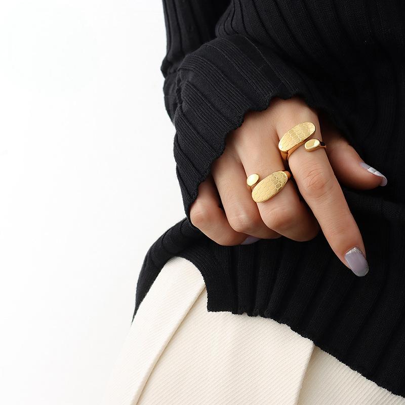 Titanium steel 18K gold plated geometric stripe ring on hand, Close-up of horizontal striped design on gold plated ring, Luxury gift box with 18K gold titanium steel jewelry, Water-resistant gold plated ring with recycled titanium steel,Two-year guarantee hypoallergenic gold tone ring