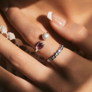 Stackable sterling silver moonstone ring on finger, Ins style moonstone ring with celestial glow, Recycled silver moonstone stacking band jewelry,Close-up of natural moonstone in silver ring setting, Minimalist moonstone ring for layered arm candy