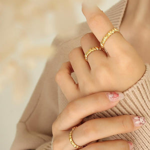 Titanium steel 18K gold plated geometric stripe ring on hand, Close-up of horizontal striped design on gold plated ring, Luxury gift box with 18K gold titanium steel jewelry, Water-resistant gold plated ring with recycled titanium steel,Two-year guarantee hypoallergenic gold tone ring