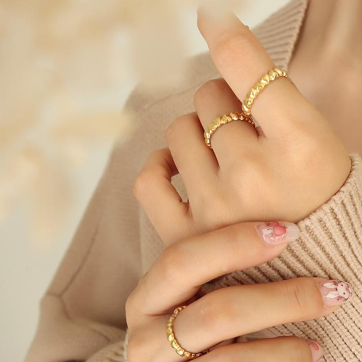 Titanium steel 18K gold plated geometric stripe ring on hand, Close-up of horizontal striped design on gold plated ring, Luxury gift box with 18K gold titanium steel jewelry, Water-resistant gold plated ring with recycled titanium steel,Two-year guarantee hypoallergenic gold tone ring