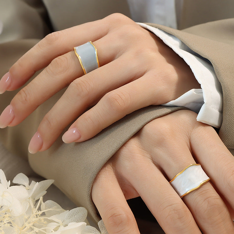Titanium steel 18K gold plated geometric stripe ring on hand, Close-up of horizontal striped design on gold plated ring, Luxury gift box with 18K gold titanium steel jewelry, Water-resistant gold plated ring with recycled titanium steel,Two-year guarantee hypoallergenic gold tone ring