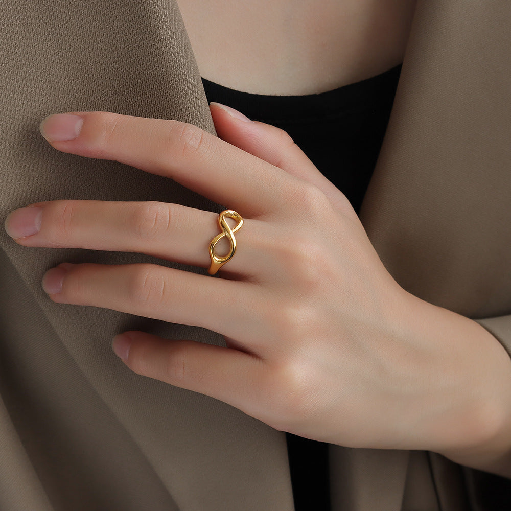 Titanium steel 18K gold plated geometric stripe ring on hand, Close-up of horizontal striped design on gold plated ring, Luxury gift box with 18K gold titanium steel jewelry, Water-resistant gold plated ring with recycled titanium steel,Two-year guarantee hypoallergenic gold tone ring