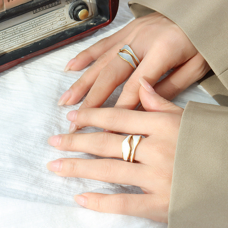 Titanium steel 18K gold plated geometric stripe ring on hand, Close-up of horizontal striped design on gold plated ring, Luxury gift box with 18K gold titanium steel jewelry, Water-resistant gold plated ring with recycled titanium steel,Two-year guarantee hypoallergenic gold tone ring