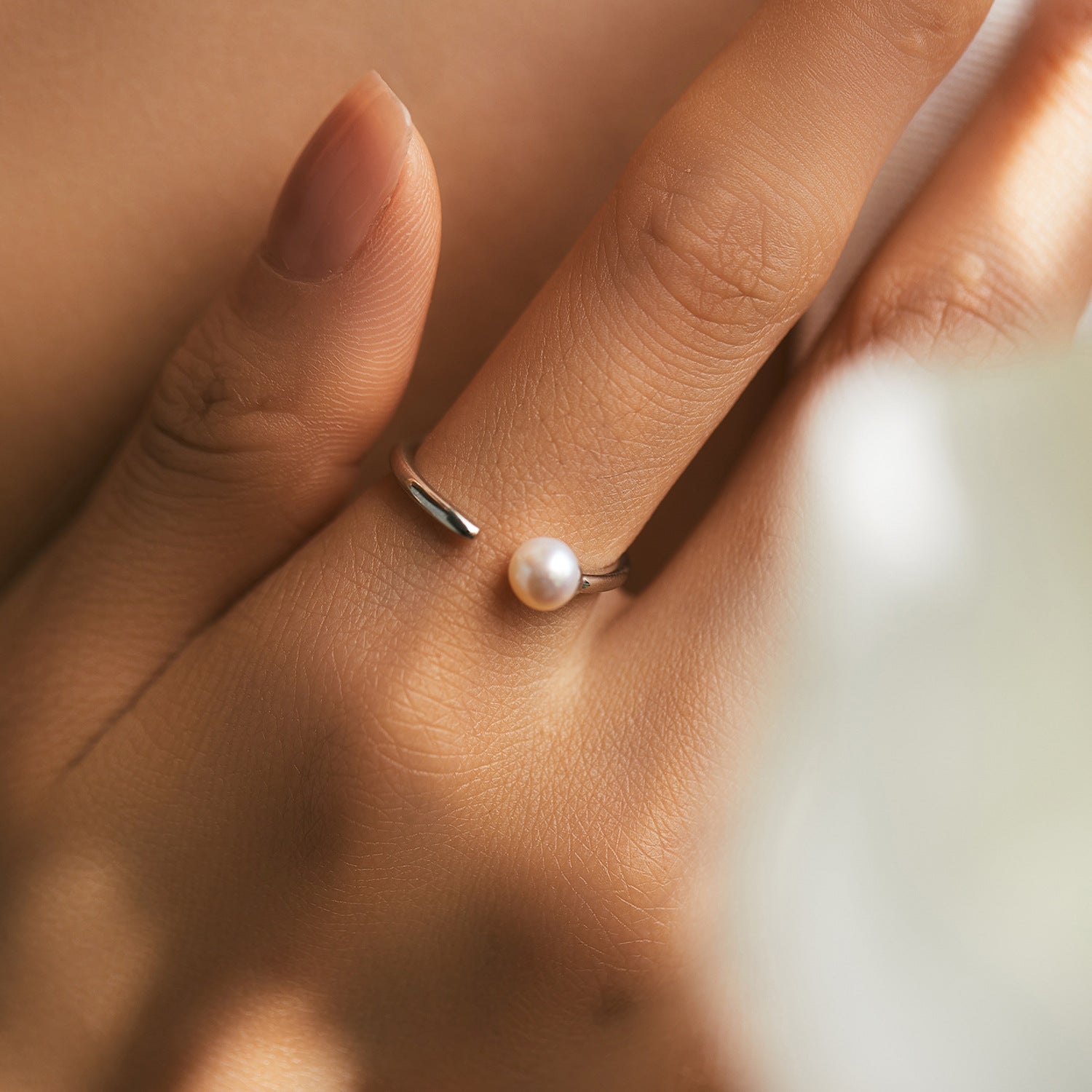 Adjustable sterling silver natural pearl ring, Organic pearl jewelry with flexible band, Recycled silver ocean-inspired ring,Close-up of natural pearl luster,Sustainable pearl ring in gift packaging