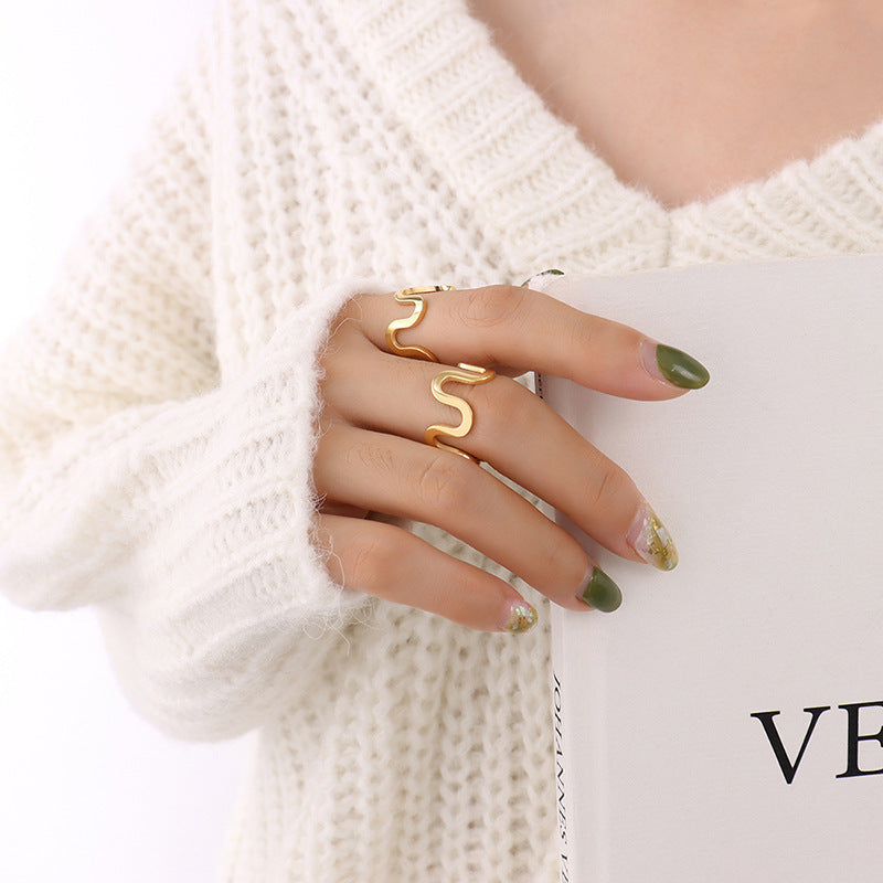 Titanium steel 18K gold plated geometric stripe ring on hand, Close-up of horizontal striped design on gold plated ring, Luxury gift box with 18K gold titanium steel jewelry, Water-resistant gold plated ring with recycled titanium steel,Two-year guarantee hypoallergenic gold tone ring