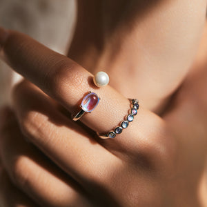 Stackable sterling silver moonstone ring on finger, Ins style moonstone ring with celestial glow, Recycled silver moonstone stacking band jewelry,Close-up of natural moonstone in silver ring setting, Minimalist moonstone ring for layered arm candy