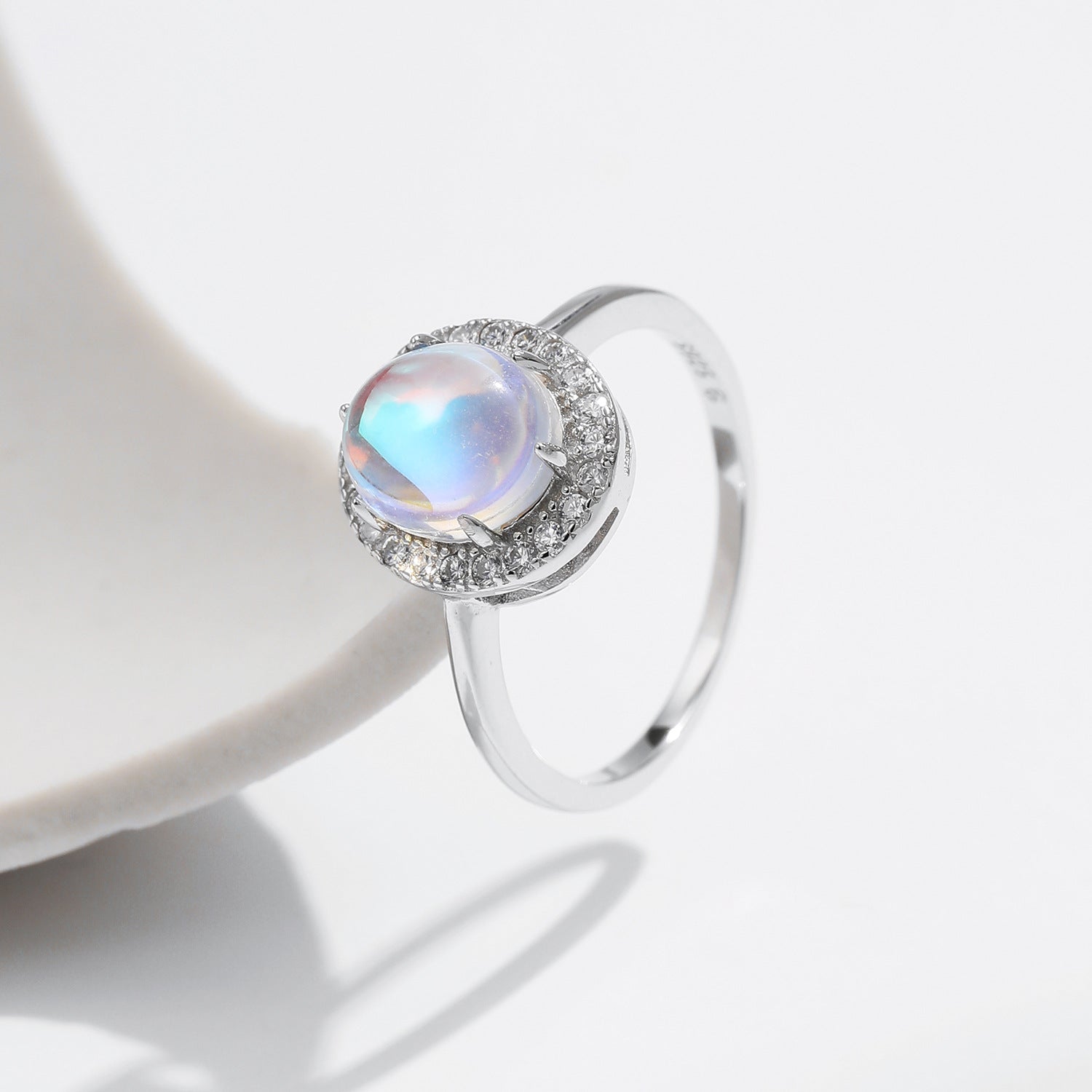 Stackable sterling silver moonstone ring on finger, Ins style moonstone ring with celestial glow, Recycled silver moonstone stacking band jewelry,Close-up of natural moonstone in silver ring setting, Minimalist moonstone ring for layered arm candy