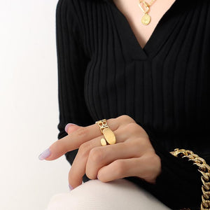 Titanium steel 18K gold plated geometric stripe ring on hand, Close-up of horizontal striped design on gold plated ring, Luxury gift box with 18K gold titanium steel jewelry, Water-resistant gold plated ring with recycled titanium steel,Two-year guarantee hypoallergenic gold tone ring