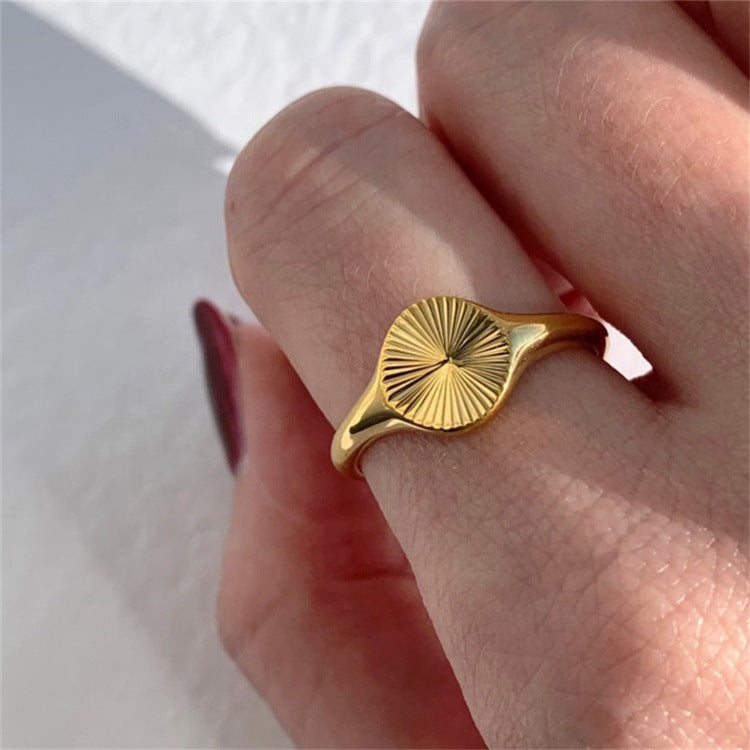 Titanium steel 18K gold plated geometric stripe ring on hand, Close-up of horizontal striped design on gold plated ring, Luxury gift box with 18K gold titanium steel jewelry, Water-resistant gold plated ring with recycled titanium steel,Two-year guarantee hypoallergenic gold tone ring