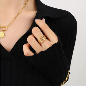 Titanium steel 18K gold plated geometric stripe ring on hand, Close-up of horizontal striped design on gold plated ring, Luxury gift box with 18K gold titanium steel jewelry, Water-resistant gold plated ring with recycled titanium steel,Two-year guarantee hypoallergenic gold tone ring