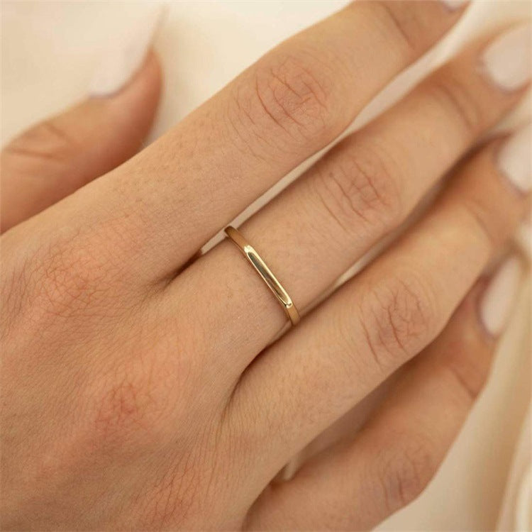 Titanium steel 18K gold plated geometric stripe ring on hand, Close-up of horizontal striped design on gold plated ring, Luxury gift box with 18K gold titanium steel jewelry, Water-resistant gold plated ring with recycled titanium steel,Two-year guarantee hypoallergenic gold tone ring