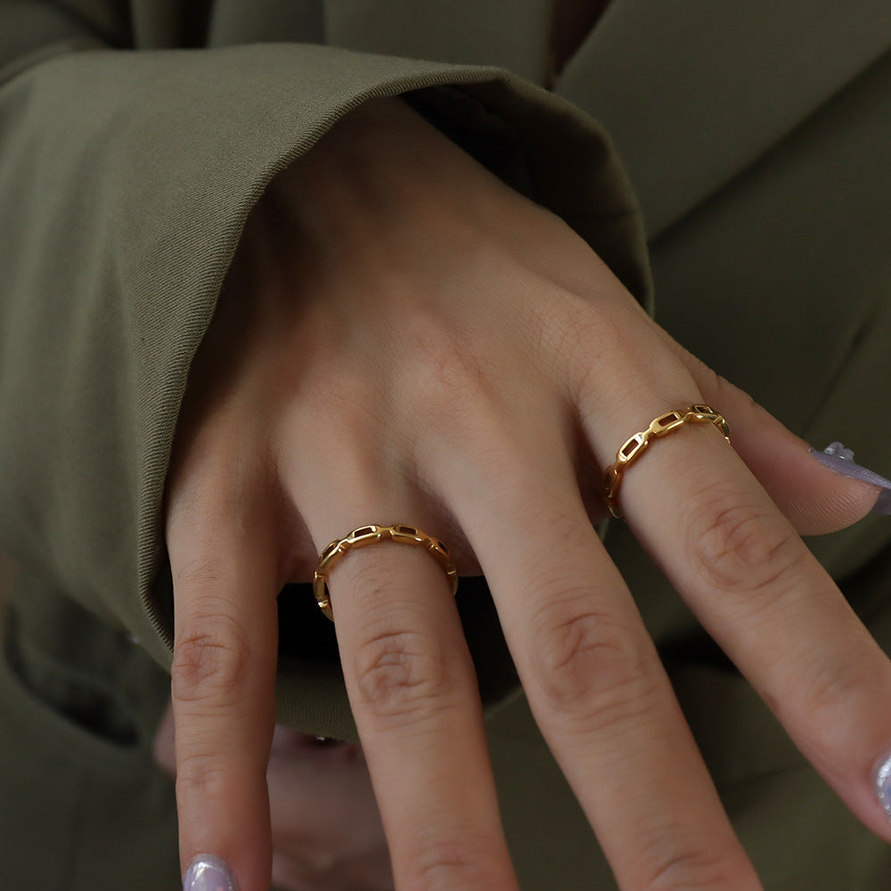 Titanium steel 18K gold plated geometric stripe ring on hand, Close-up of horizontal striped design on gold plated ring, Luxury gift box with 18K gold titanium steel jewelry, Water-resistant gold plated ring with recycled titanium steel,Two-year guarantee hypoallergenic gold tone ring