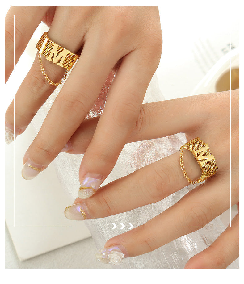 Titanium steel 18K gold plated geometric stripe ring on hand, Close-up of horizontal striped design on gold plated ring, Luxury gift box with 18K gold titanium steel jewelry, Water-resistant gold plated ring with recycled titanium steel,Two-year guarantee hypoallergenic gold tone ring