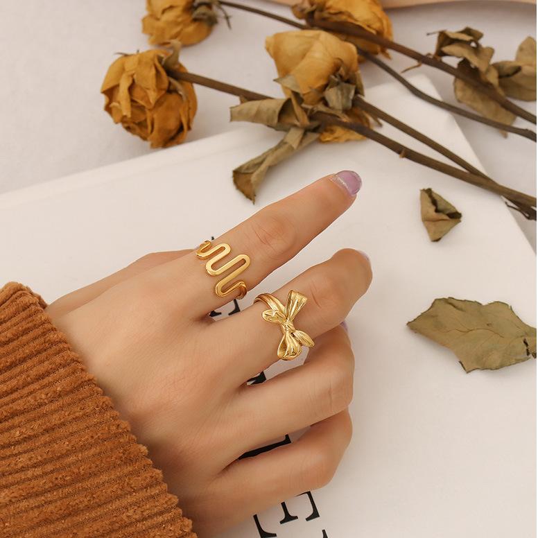 Titanium steel 18K gold plated geometric stripe ring on hand, Close-up of horizontal striped design on gold plated ring, Luxury gift box with 18K gold titanium steel jewelry, Water-resistant gold plated ring with recycled titanium steel,Two-year guarantee hypoallergenic gold tone ring