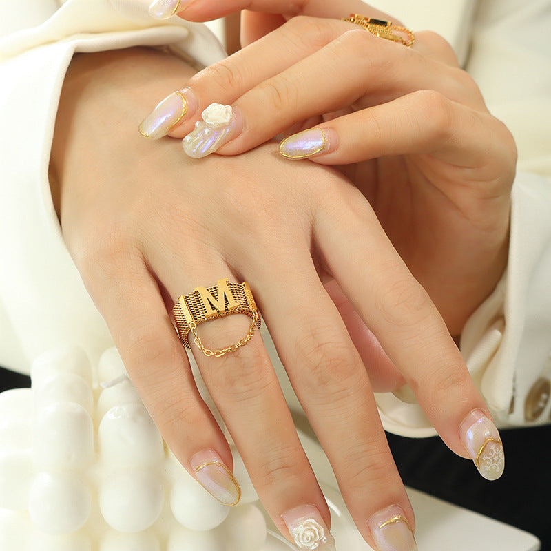 Titanium steel 18K gold plated geometric stripe ring on hand, Close-up of horizontal striped design on gold plated ring, Luxury gift box with 18K gold titanium steel jewelry, Water-resistant gold plated ring with recycled titanium steel,Two-year guarantee hypoallergenic gold tone ring