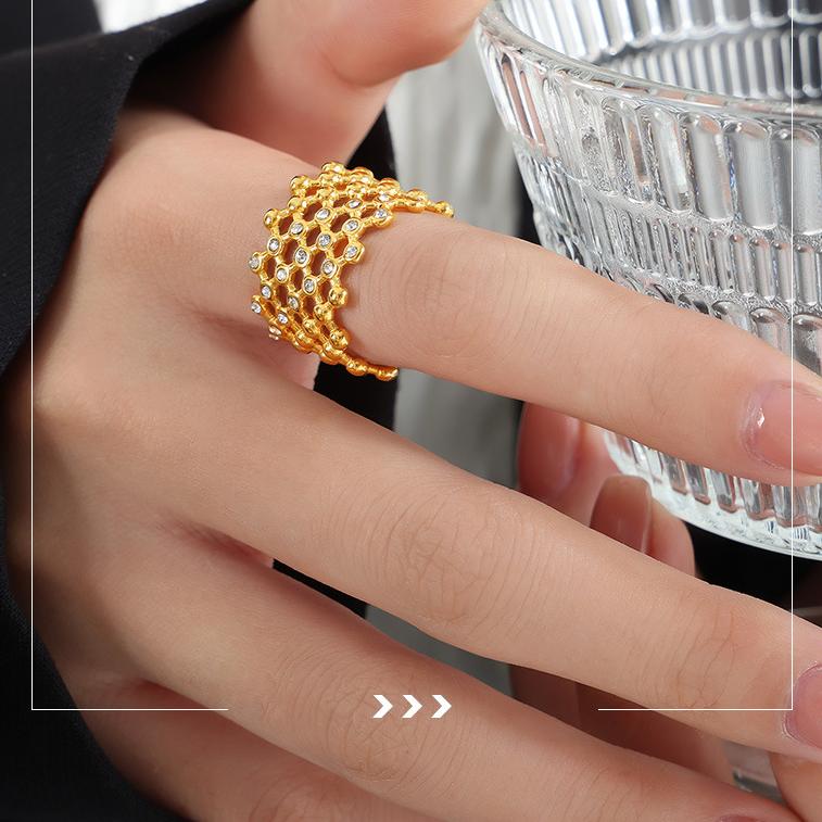 Titanium steel 18K gold plated geometric stripe ring on hand, Close-up of horizontal striped design on gold plated ring, Luxury gift box with 18K gold titanium steel jewelry, Water-resistant gold plated ring with recycled titanium steel,Two-year guarantee hypoallergenic gold tone ring