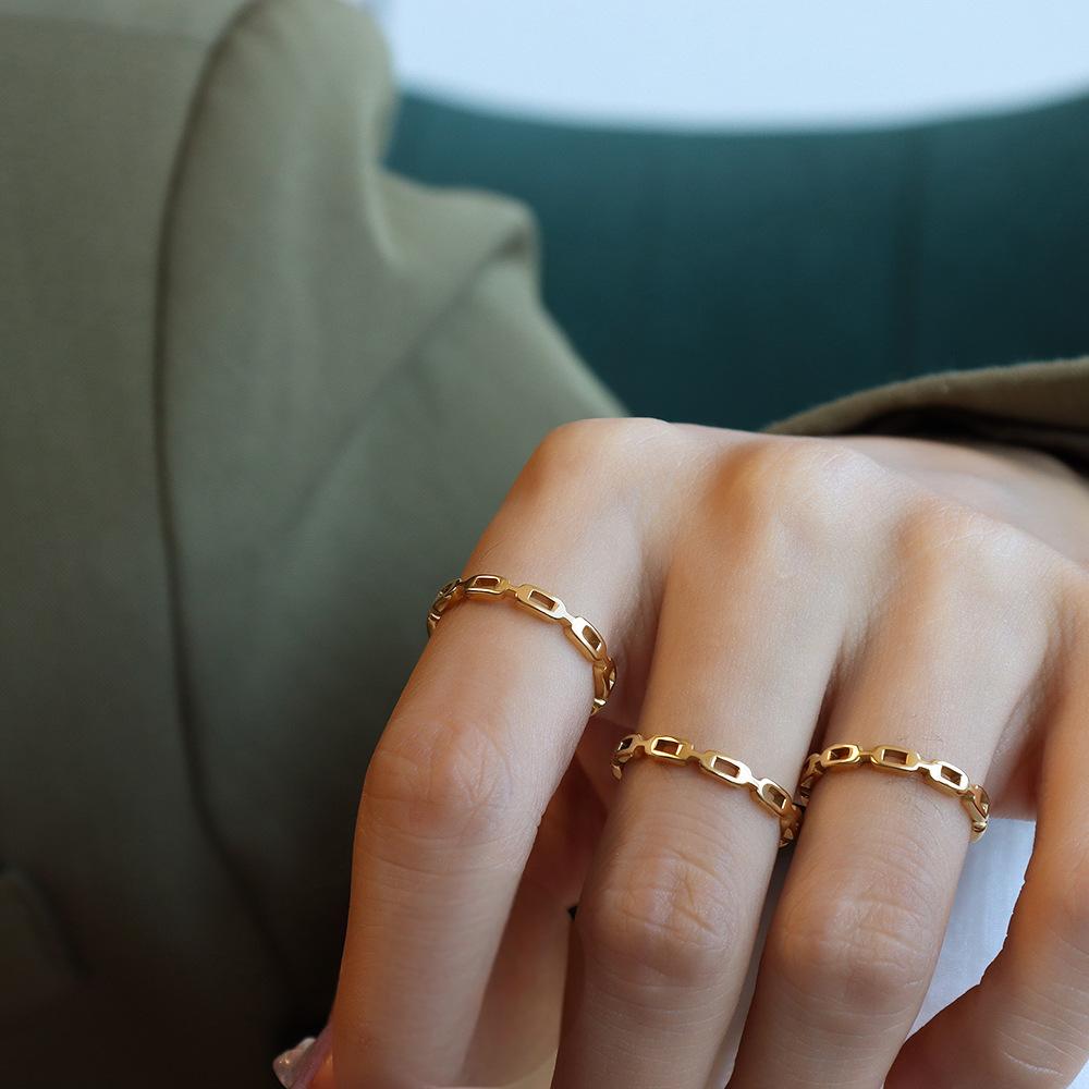 Titanium steel 18K gold plated geometric stripe ring on hand, Close-up of horizontal striped design on gold plated ring, Luxury gift box with 18K gold titanium steel jewelry, Water-resistant gold plated ring with recycled titanium steel,Two-year guarantee hypoallergenic gold tone ring