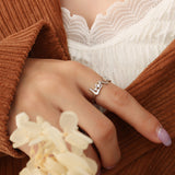 Titanium steel 18K gold plated geometric stripe ring on hand, Close-up of horizontal striped design on gold plated ring, Luxury gift box with 18K gold titanium steel jewelry, Water-resistant gold plated ring with recycled titanium steel,Two-year guarantee hypoallergenic gold tone ring