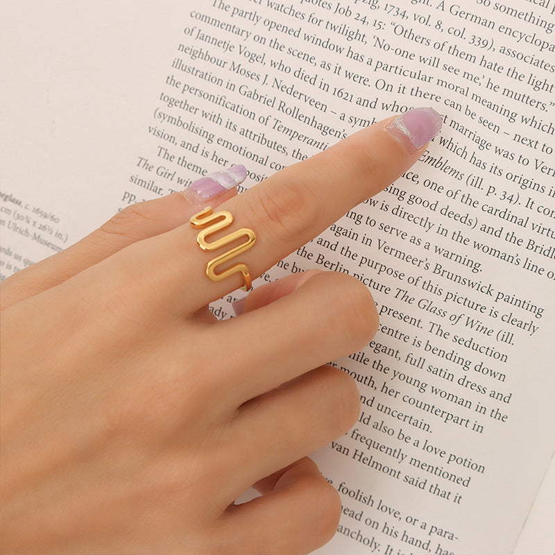 Titanium steel 18K gold plated geometric stripe ring on hand, Close-up of horizontal striped design on gold plated ring, Luxury gift box with 18K gold titanium steel jewelry, Water-resistant gold plated ring with recycled titanium steel,Two-year guarantee hypoallergenic gold tone ring