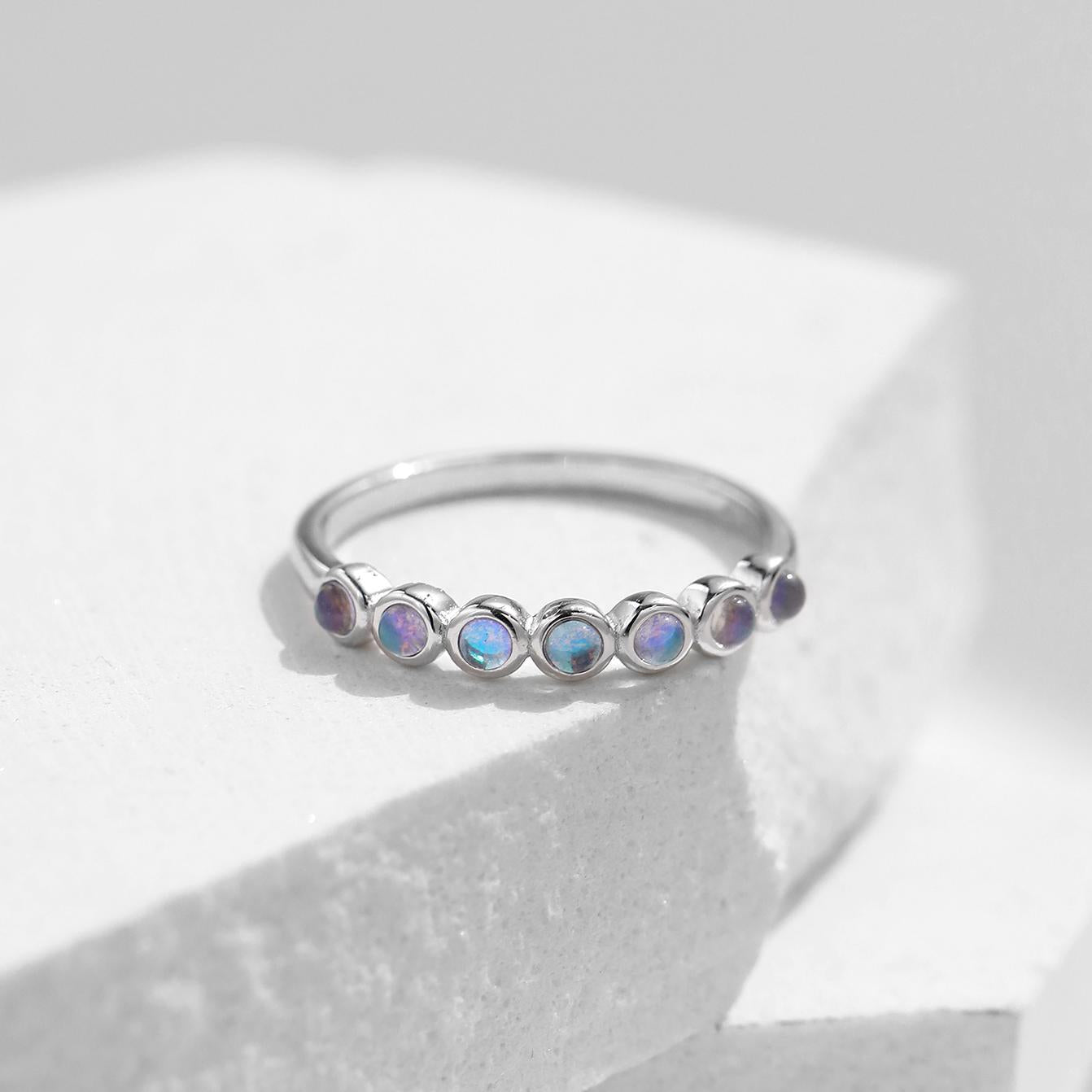 Stackable sterling silver moonstone ring on finger, Ins style moonstone ring with celestial glow, Recycled silver moonstone stacking band jewelry,Close-up of natural moonstone in silver ring setting, Minimalist moonstone ring for layered arm candy