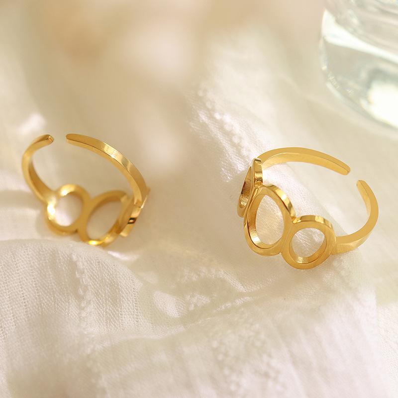 Titanium steel 18K gold plated geometric stripe ring on hand, Close-up of horizontal striped design on gold plated ring, Luxury gift box with 18K gold titanium steel jewelry, Water-resistant gold plated ring with recycled titanium steel,Two-year guarantee hypoallergenic gold tone ring