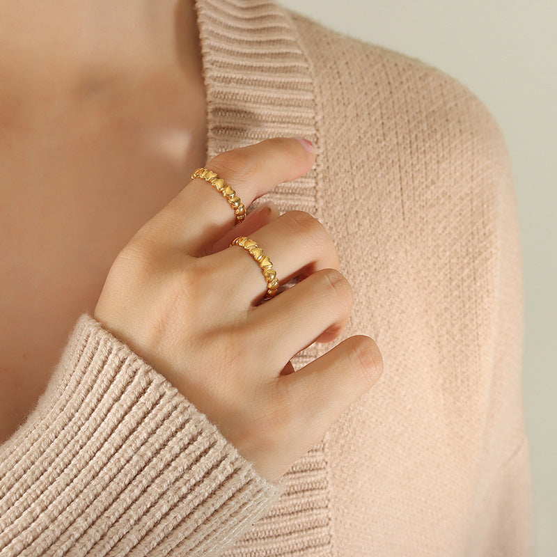 Titanium steel 18K gold plated geometric stripe ring on hand, Close-up of horizontal striped design on gold plated ring, Luxury gift box with 18K gold titanium steel jewelry, Water-resistant gold plated ring with recycled titanium steel,Two-year guarantee hypoallergenic gold tone ring