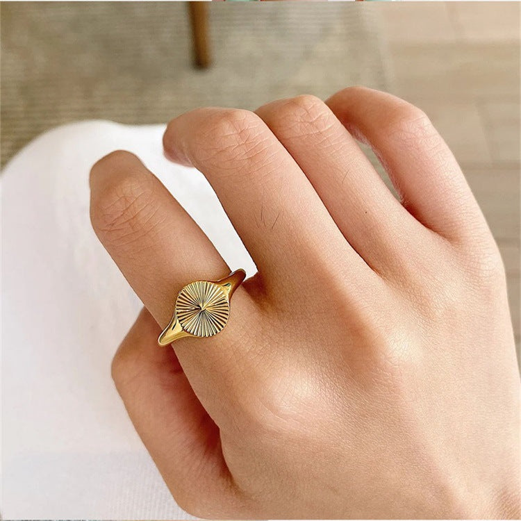 Titanium steel 18K gold plated geometric stripe ring on hand, Close-up of horizontal striped design on gold plated ring, Luxury gift box with 18K gold titanium steel jewelry, Water-resistant gold plated ring with recycled titanium steel,Two-year guarantee hypoallergenic gold tone ring