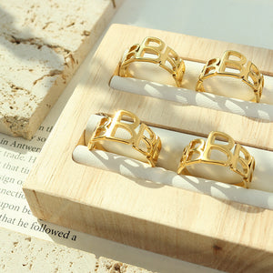 Titanium steel 18K gold plated geometric stripe ring on hand, Close-up of horizontal striped design on gold plated ring, Luxury gift box with 18K gold titanium steel jewelry, Water-resistant gold plated ring with recycled titanium steel,Two-year guarantee hypoallergenic gold tone ring