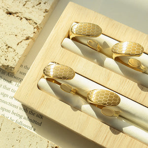 Titanium steel 18K gold plated geometric stripe ring on hand, Close-up of horizontal striped design on gold plated ring, Luxury gift box with 18K gold titanium steel jewelry, Water-resistant gold plated ring with recycled titanium steel,Two-year guarantee hypoallergenic gold tone ring