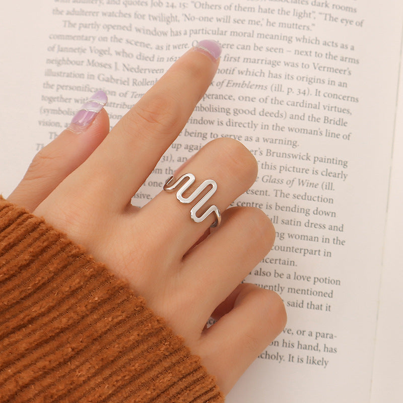 Titanium steel 18K gold plated geometric stripe ring on hand, Close-up of horizontal striped design on gold plated ring, Luxury gift box with 18K gold titanium steel jewelry, Water-resistant gold plated ring with recycled titanium steel,Two-year guarantee hypoallergenic gold tone ring