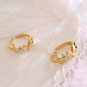 Titanium steel 18K gold plated geometric stripe ring on hand, Close-up of horizontal striped design on gold plated ring, Luxury gift box with 18K gold titanium steel jewelry, Water-resistant gold plated ring with recycled titanium steel,Two-year guarantee hypoallergenic gold tone ring