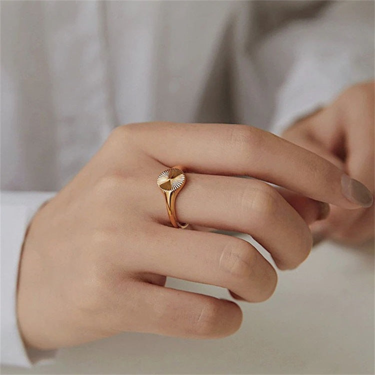 Titanium steel 18K gold plated geometric stripe ring on hand, Close-up of horizontal striped design on gold plated ring, Luxury gift box with 18K gold titanium steel jewelry, Water-resistant gold plated ring with recycled titanium steel,Two-year guarantee hypoallergenic gold tone ring