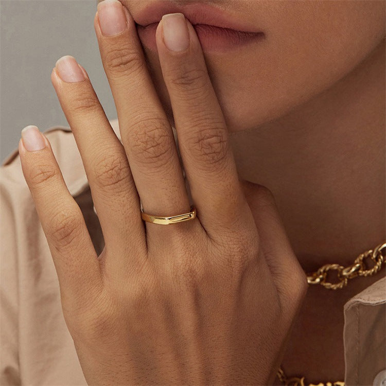 Titanium steel 18K gold plated geometric stripe ring on hand, Close-up of horizontal striped design on gold plated ring, Luxury gift box with 18K gold titanium steel jewelry, Water-resistant gold plated ring with recycled titanium steel,Two-year guarantee hypoallergenic gold tone ring