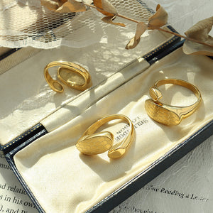 Titanium steel 18K gold plated geometric stripe ring on hand, Close-up of horizontal striped design on gold plated ring, Luxury gift box with 18K gold titanium steel jewelry, Water-resistant gold plated ring with recycled titanium steel,Two-year guarantee hypoallergenic gold tone ring