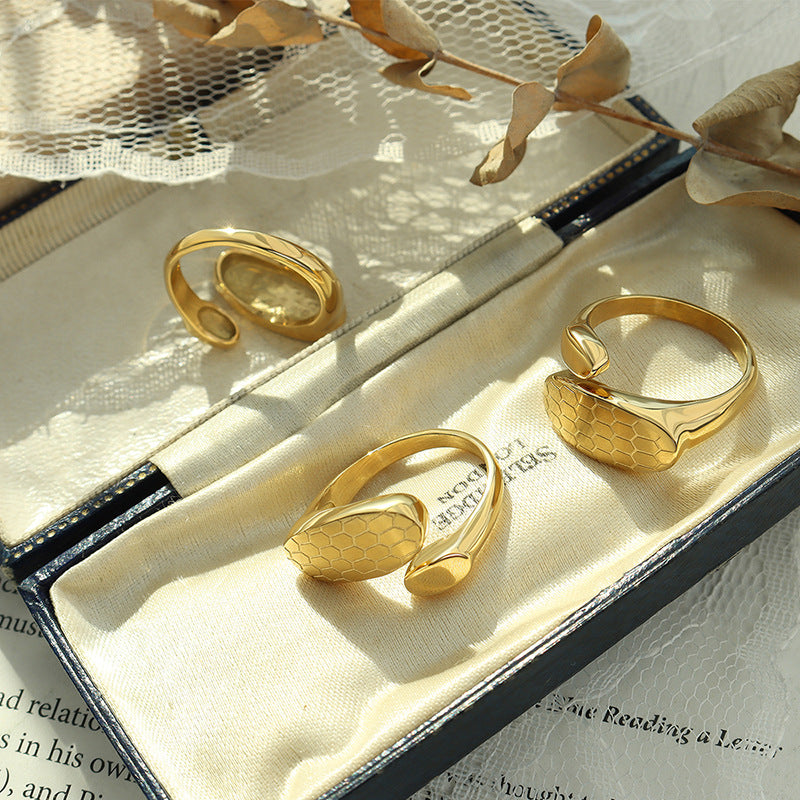 Titanium steel 18K gold plated geometric stripe ring on hand, Close-up of horizontal striped design on gold plated ring, Luxury gift box with 18K gold titanium steel jewelry, Water-resistant gold plated ring with recycled titanium steel,Two-year guarantee hypoallergenic gold tone ring