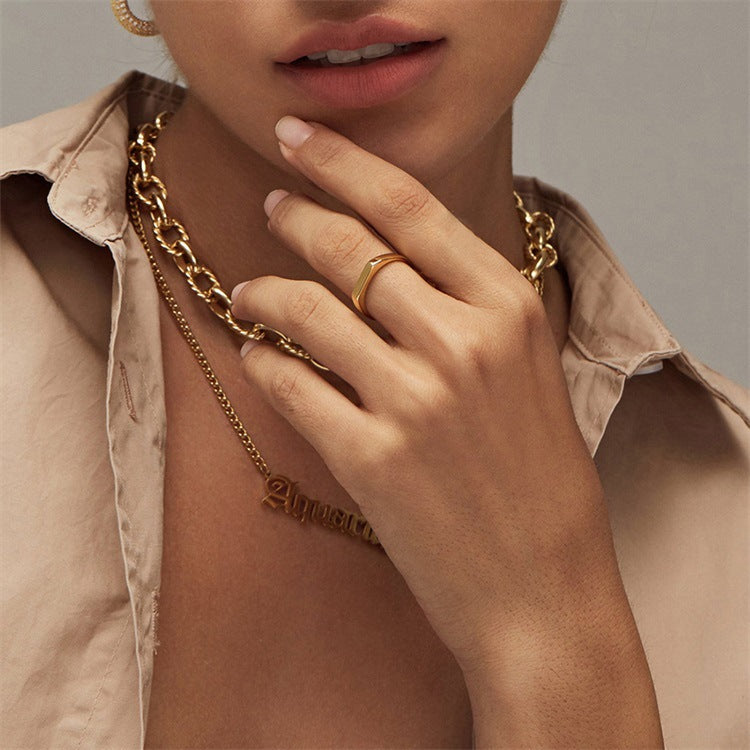 Titanium steel 18K gold plated geometric stripe ring on hand, Close-up of horizontal striped design on gold plated ring, Luxury gift box with 18K gold titanium steel jewelry, Water-resistant gold plated ring with recycled titanium steel,Two-year guarantee hypoallergenic gold tone ring