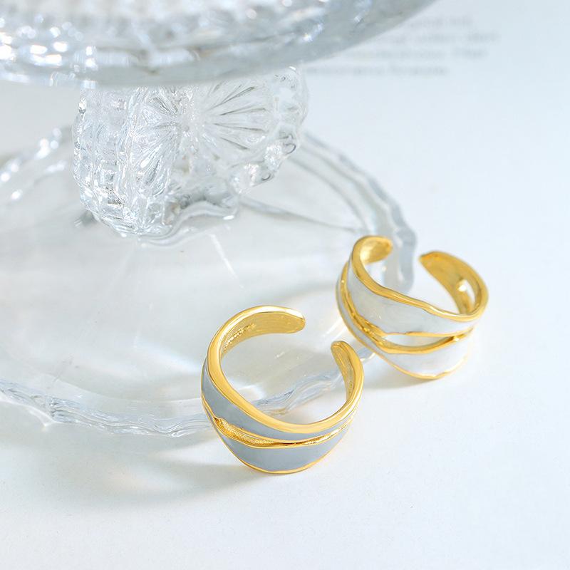 Titanium steel 18K gold plated geometric stripe ring on hand, Close-up of horizontal striped design on gold plated ring, Luxury gift box with 18K gold titanium steel jewelry, Water-resistant gold plated ring with recycled titanium steel,Two-year guarantee hypoallergenic gold tone ring