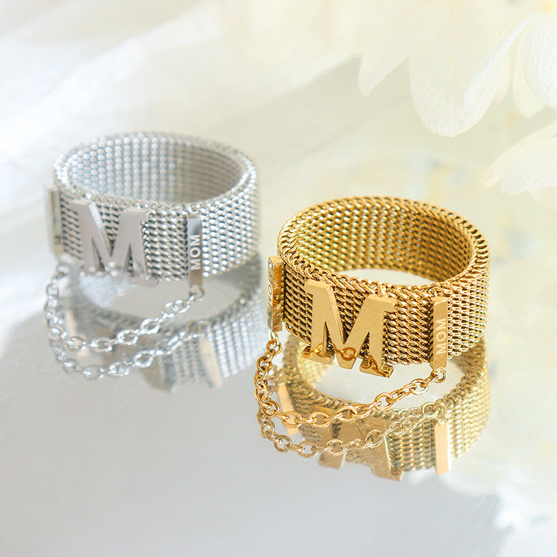 Titanium steel 18K gold plated geometric stripe ring on hand, Close-up of horizontal striped design on gold plated ring, Luxury gift box with 18K gold titanium steel jewelry, Water-resistant gold plated ring with recycled titanium steel,Two-year guarantee hypoallergenic gold tone ring