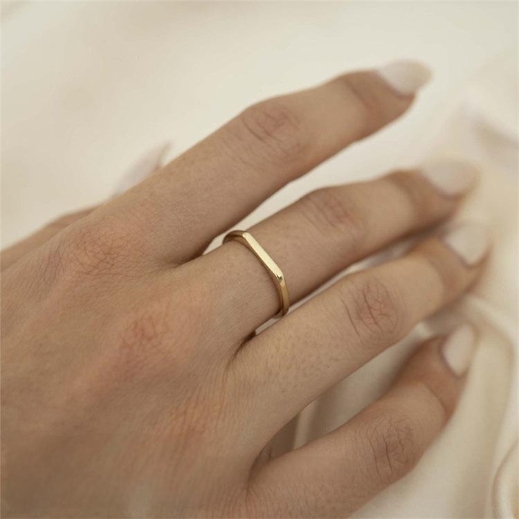 Titanium steel 18K gold plated geometric stripe ring on hand, Close-up of horizontal striped design on gold plated ring, Luxury gift box with 18K gold titanium steel jewelry, Water-resistant gold plated ring with recycled titanium steel,Two-year guarantee hypoallergenic gold tone ring