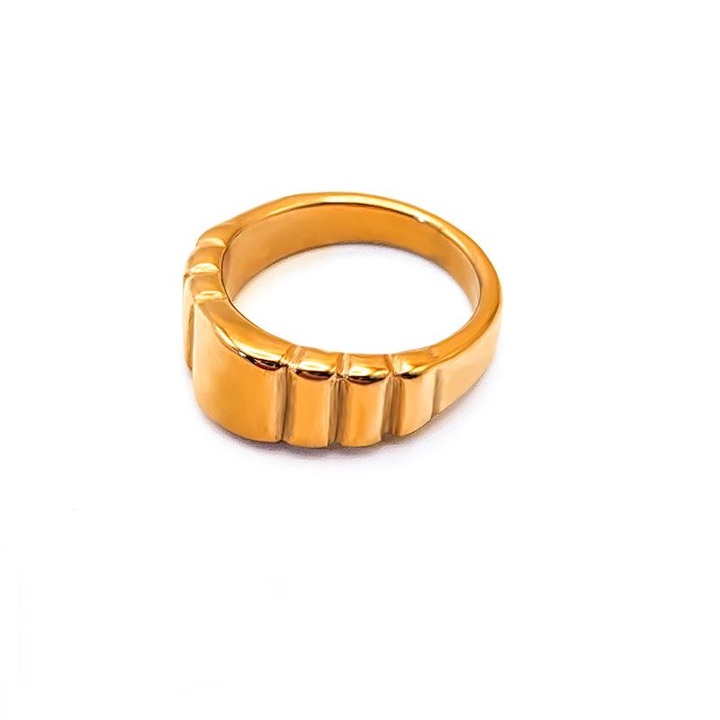 Titanium steel 18K gold plated geometric stripe ring on hand, Close-up of horizontal striped design on gold plated ring, Luxury gift box with 18K gold titanium steel jewelry, Water-resistant gold plated ring with recycled titanium steel,Two-year guarantee hypoallergenic gold tone ring
