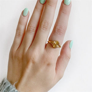 Titanium steel 18K gold plated geometric stripe ring on hand, Close-up of horizontal striped design on gold plated ring, Luxury gift box with 18K gold titanium steel jewelry, Water-resistant gold plated ring with recycled titanium steel,Two-year guarantee hypoallergenic gold tone ring