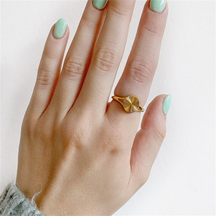 Titanium steel 18K gold plated geometric stripe ring on hand, Close-up of horizontal striped design on gold plated ring, Luxury gift box with 18K gold titanium steel jewelry, Water-resistant gold plated ring with recycled titanium steel,Two-year guarantee hypoallergenic gold tone ring
