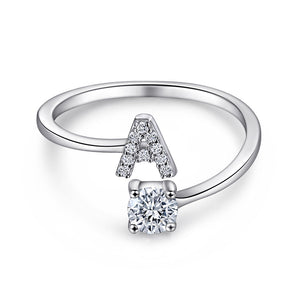 Close-up of S925 sterling silver rhodium-plated adjustable letter A ring with zirconia center stone, Top view of 26 alphabet sterling silver rings spread display with adjustable clasp detail, Side-lit shot of rhodium-plated letter S ring worn on finger with sparkling zirconia, Macro view of zirconia stone brilliance and rhodium-plated silver surface texture